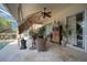 Relaxing covered patio area with comfortable seating and lush tropical landscaping at 4435 Fairway Oaks Dr, Mulberry, FL 33860