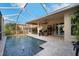 Screened pool with covered patio and lush tropical landscaping in the backyard at 4435 Fairway Oaks Dr, Mulberry, FL 33860