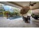 Private screened pool area features lush tropical landscaping and comfortable seating at 4435 Fairway Oaks Dr, Mulberry, FL 33860