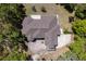An aerial view shows the layout of this home and surrounding trees at 445 Se 98Th Ave, Webster, FL 33597