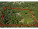 Aerial view outlining a secluded property surrounded by dense trees at 445 Se 98Th Ave, Webster, FL 33597