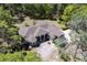 Aerial view of the home with manicured landscaping, circular driveway, and surrounded by trees at 445 Se 98Th Ave, Webster, FL 33597