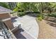 This home's backyard features a concrete patio, lawn, and mature landscaping at 445 Se 98Th Ave, Webster, FL 33597