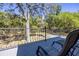 Enjoy scenic backyard views from the home's outdoor deck and wrought iron railing at 445 Se 98Th Ave, Webster, FL 33597