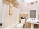 Functional bathroom with a combined tub and shower unit, a classic pedestal sink, and neutral tile work at 445 Se 98Th Ave, Webster, FL 33597