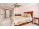 Primary bedroom featuring a ceiling fan, bed, and a wet bar at 445 Se 98Th Ave, Webster, FL 33597