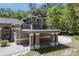 Exterior view of a home highlighting a garage, a covered parking area, and a second story balcony at 445 Se 98Th Ave, Webster, FL 33597