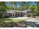 Stunning two-story home with arched windows, red door, balcony, and a circular driveway at 445 Se 98Th Ave, Webster, FL 33597