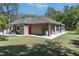 Exterior shot of the rear of the home showing the beautiful yard and landscaping at 445 Se 98Th Ave, Webster, FL 33597