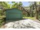 Detached garage with carport featuring ample space for parking and storage at 445 Se 98Th Ave, Webster, FL 33597