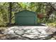 Detached garage with carport featuring ample space for parking and storage at 445 Se 98Th Ave, Webster, FL 33597