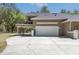 Lovely garage with a balcony above and a wide parking pad for multiple vehicles at 445 Se 98Th Ave, Webster, FL 33597