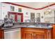 Wet bar area with granite counters, stainless steel dishwasher, and modern faucet with unique decorations at 445 Se 98Th Ave, Webster, FL 33597