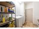 Convenient laundry room includes shelving and modern washer and dryer at 445 Se 98Th Ave, Webster, FL 33597