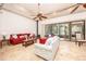Spacious living room features tile floors, a ceiling fan, a fireplace, and access to screened porch at 445 Se 98Th Ave, Webster, FL 33597