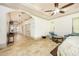 Open main bedroom featuring sitting area, high ceilings, and access to the hallway at 445 Se 98Th Ave, Webster, FL 33597