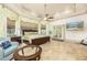 Spacious main bedroom with tray ceiling, fan, seating area, and large windows at 445 Se 98Th Ave, Webster, FL 33597