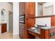 Built-in office nook with granite countertop, custom cabinetry, and convenient access to the hallway at 445 Se 98Th Ave, Webster, FL 33597
