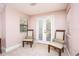 Bright sitting room features neutral decor, plush carpeting, and French doors leading to outdoor area at 445 Se 98Th Ave, Webster, FL 33597