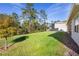 Large backyard with green grass and wooded area at 805 Baylor Dr, Deltona, FL 32725