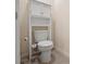 A cozy bathroom features a toilet with a unique shelving unit and storage cabinet above at 805 Baylor Dr, Deltona, FL 32725