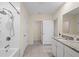 Bathroom features a shower, granite counters, and a view into another area in the home at 805 Baylor Dr, Deltona, FL 32725