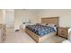 Bright bedroom with light carpet, wooden bed frame, and a vanity perfect for getting ready at 805 Baylor Dr, Deltona, FL 32725