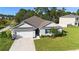 Charming single-story home with a well-manicured lawn, two car garage, and beautiful landscaping at 805 Baylor Dr, Deltona, FL 32725