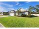 Single-story home featuring a vibrant green lawn and an attached two-car garage at 805 Baylor Dr, Deltona, FL 32725
