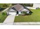 Charming home with lush lawn, paved driveway, and an attached two car garage at 805 Baylor Dr, Deltona, FL 32725