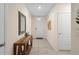 Hallway features wood console table with décor and artwork, and leads to the front door at 805 Baylor Dr, Deltona, FL 32725