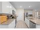 Bright kitchen featuring granite countertops, stainless steel appliances, and white cabinets at 805 Baylor Dr, Deltona, FL 32725
