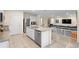 Modern kitchen features granite countertops, a stainless steel dishwasher and overlooks the living room at 805 Baylor Dr, Deltona, FL 32725