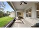 Spacious screened porch features cozy seating and a ceiling fan, perfect for outdoor living at 805 Baylor Dr, Deltona, FL 32725