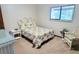 Bedroom with floral bedspread, seating, and natural light at 568 Gainsboro St, Deltona, FL 32725