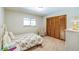 Bedroom featuring a floral bedspread and wood-paneled closet at 568 Gainsboro St, Deltona, FL 32725