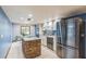 Modern kitchen with stainless steel appliances, white cabinets, and a brick-accented center island at 568 Gainsboro St, Deltona, FL 32725
