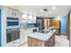 Well-equipped kitchen with white cabinetry, stainless steel appliances, and a charming brick island at 568 Gainsboro St, Deltona, FL 32725