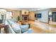 Spacious living room with hardwood floors, a brick fireplace, and plenty of room for entertaining at 568 Gainsboro St, Deltona, FL 32725