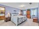 Serene main bedroom with plush carpeting, a king-size bed, and a soothing blue color scheme at 568 Gainsboro St, Deltona, FL 32725