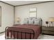 Calm bedroom featuring a black metal bed frame, accent wall art, and natural light at 9124 Sw 158Th Ln, Dunnellon, FL 34432