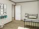 Well-lit bedroom featuring artwork and hardwood floors at 9124 Sw 158Th Ln, Dunnellon, FL 34432