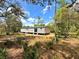Exterior of home, surrounded by woods and ground foliage at 9124 Sw 158Th Ln, Dunnellon, FL 34432