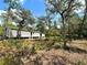 Exterior of house, surrounded by woods and ground foliage at 9124 Sw 158Th Ln, Dunnellon, FL 34432