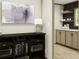 Stylish living room featuring built in shelving, and a view into the coffee bar and kitchen at 9124 Sw 158Th Ln, Dunnellon, FL 34432