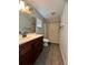 Bathroom with a walk-in shower and stylish vanity and updated fixtures at 12113 Calaboose Ct, Orlando, FL 32828