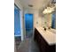 The bathroom features a dark vanity and a spacious walk-in closet at 12113 Calaboose Ct, Orlando, FL 32828