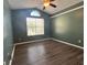 Bedroom with wood floors, fan and window at 12113 Calaboose Ct, Orlando, FL 32828