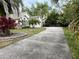 Well-maintained house with a long driveway and beautiful landscaping at 12113 Calaboose Ct, Orlando, FL 32828
