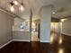 Open floor plan showcasing the modern kitchen with white cabinets and stainless steel appliances adjacent to the dining and living areas at 12113 Calaboose Ct, Orlando, FL 32828